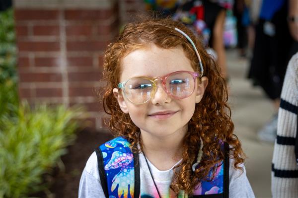 girl with glasses smiling